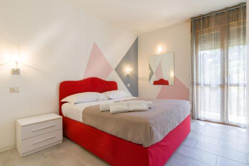 a bedroom with a large bed with a red headboard at I SOLI in Verona