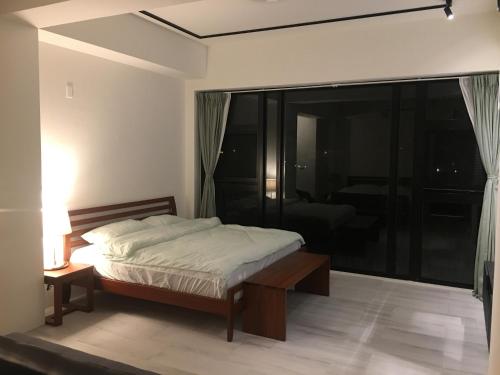 Postel nebo postele na pokoji v ubytování 方興ToP會館 全新包棟電梯民宿