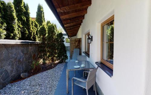a patio with a table and chairs next to a building at Appartements "Da Zillertaler und die Geigerin" in Mayrhofen