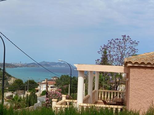 a balcony of a house with a view of the water at Villa Casa Kenaz in El Campello