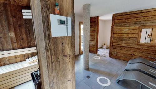 a bathroom with wooden walls and a sink at Appartements "Da Zillertaler und die Geigerin" in Mayrhofen