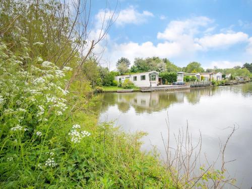 vistas a un río con casas y flores en Fantastic villa in Ooltgensplaat with jetty, en Ooltgensplaat