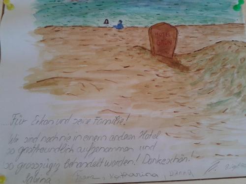 a cake with a drawing of a beach at Hotel Grün in Kızılot