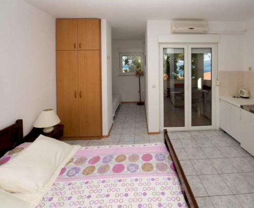 Il comprend une chambre avec un grand lit et une cuisine. dans l'établissement Studio apartment in Duce with sea view, balcony, air conditioning, WiFi 132-5, à Duće