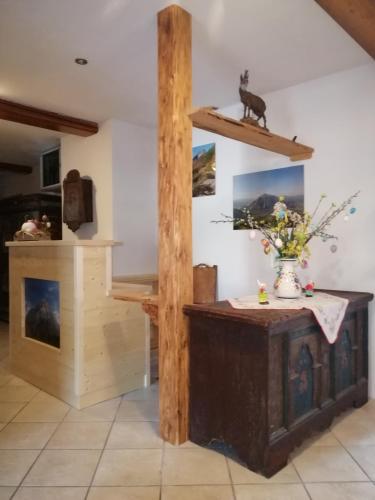 a room with a table and a vase of flowers at Ferienhof Gindl und Gästehaus Gindl in Tauplitz