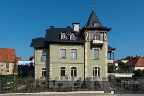 a large house with a tower on top of it at VILLA zeitlos - PfauenAuge in Traunstein