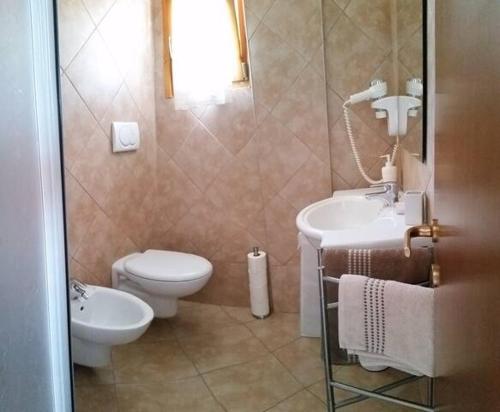 a bathroom with a toilet and a sink at Aliki House in Alyki