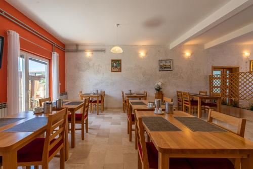 a dining room with wooden tables and chairs at Bed & Breakfast Maki in Biograd na Moru