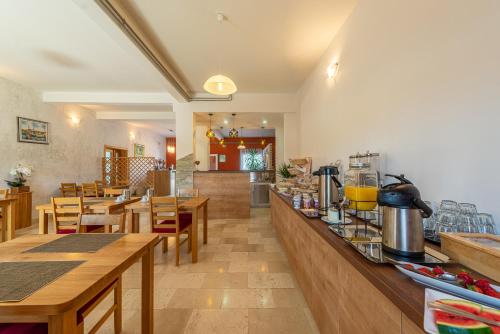 a restaurant with wooden tables and chairs and a counter at Bed & Breakfast Maki in Biograd na Moru