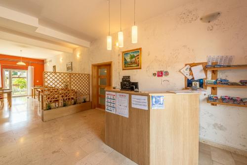 a kitchen with a counter and a dining room at Bed & Breakfast Maki in Biograd na Moru