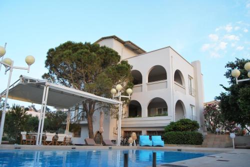a building with a pool in front of it at Chrysiida Suites in Tersanas