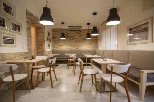 a restaurant with tables and chairs in a room at villa pergola in Trebinje