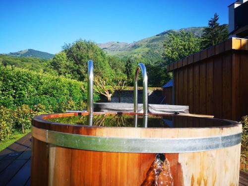 a water fountain in the middle of a yard at L'Argalyde Esprit Pyrénées Wellness & Cycling in Ayzac-Ost