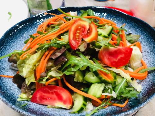 a salad in a blue bowl on a table at Palms Retreat in Fulhadhoo
