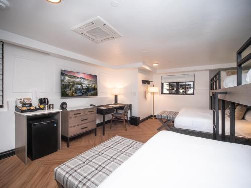 a hotel room with a bed and a desk at Gravity Haus Vail in Vail