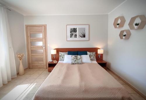 Postel nebo postele na pokoji v ubytování LAGO Apartamenty i pokoje