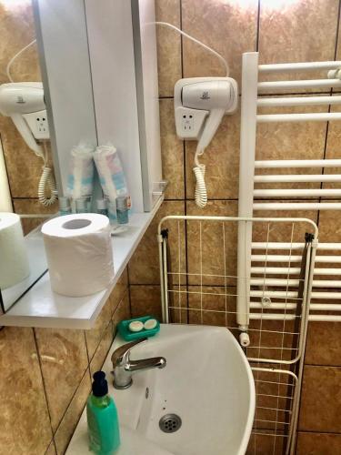 a bathroom with a sink and a mirror at Casa Ecaterina 2 Mai in 2 Mai