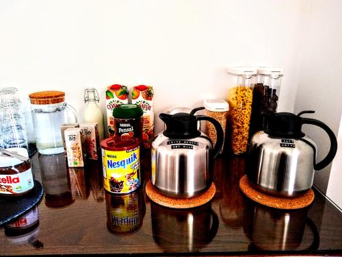 a counter with two kettles and other food items at Residencial Douro in Peso da Régua
