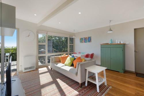 a living room with a couch and a table at The Love Shack in Pambula