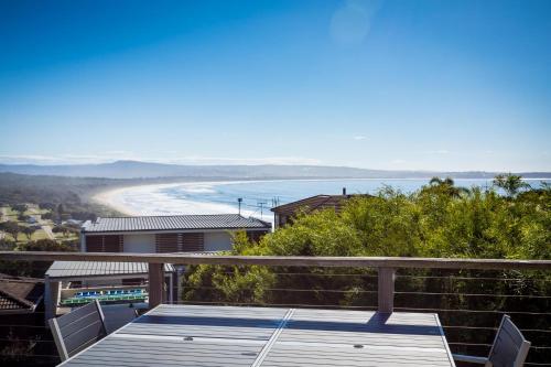 a view of the beach from the balcony of a house at The Love Shack in Pambula