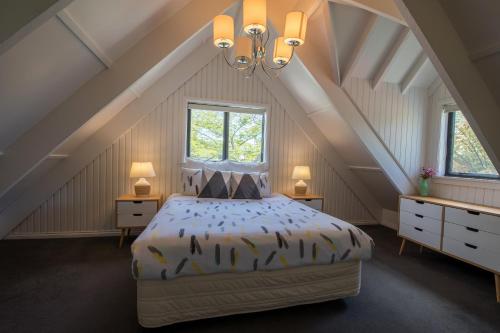a bedroom with a large bed in a attic at Gemini Lodge in Rotorua