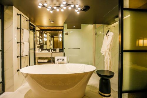 a bathroom with a large tub and a sink at InterContinental Dhaka by IHG in Dhaka