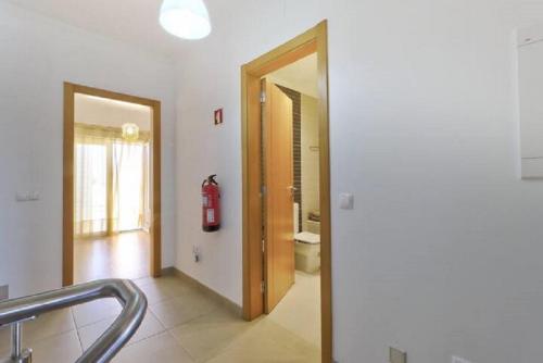 a bathroom with a toilet and a fire hydrant in it at MORADIA DO SOL in Olhão