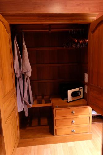 a cupboard with a drawer and a microwave in it at Namtok Sarika Resotel in Nakhon Nayok