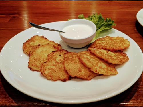a plate of fried food with a bowl of dipping sauce at Forest House in Tatariv