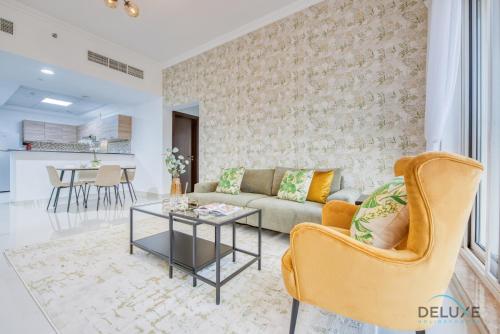 a living room with a couch and a table at Sunny 1BR at Canal Residences West Dubai Sports City by Deluxe Holiday Homes in Dubai