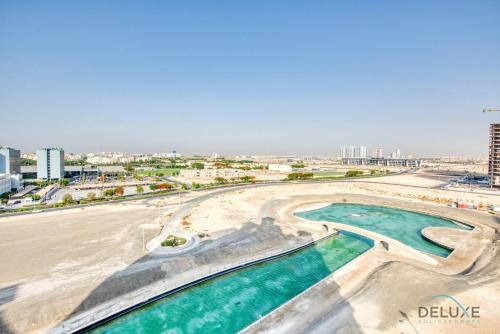 a view of a beach in dubai with buildings at Sunny 1BR at Canal Residences West Dubai Sports City by Deluxe Holiday Homes in Dubai