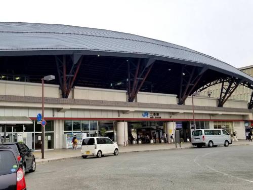 a parking lot with cars parked in front of a building at Naganoya in Kyoto