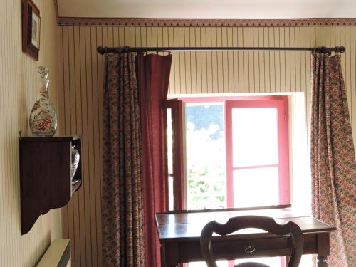 a window with a table and a chair in front of it at Le Domaine de Mestré, The Originals Relais in Fontevraud-l'Abbaye