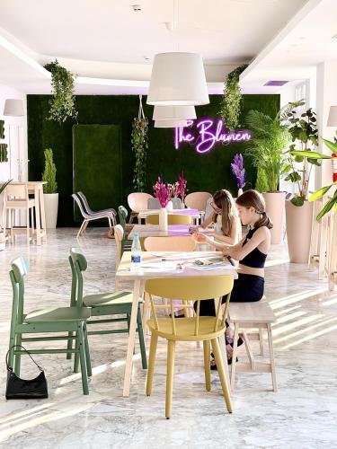two women sitting at a table in a store at Hotel Blumen in San Benedetto del Tronto