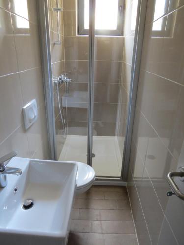 a bathroom with a shower and a toilet and a sink at Camping Mia Bungalow & Mobile Home in Biograd na Moru