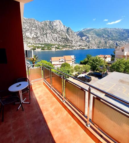 a balcony with a view of the water and mountains at Hotel Bokeljski Dvori in Kotor