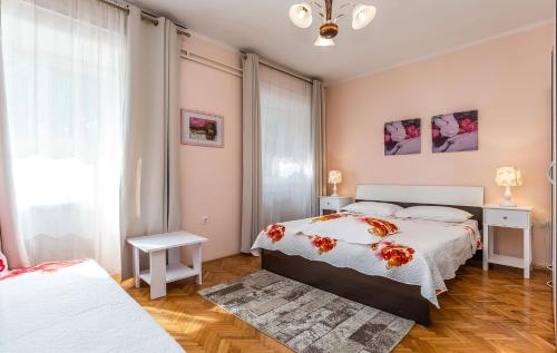 a bedroom with two beds and a window at Apartments and Rooms Lago Rupa in Rupa