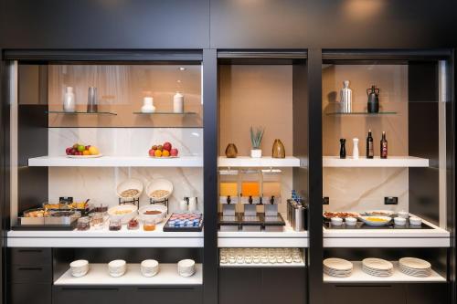 a display case in a kitchen with food items at Savhotel Fiera Bologna in Bologna