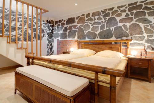 two beds in a room with a stone wall at Historische Seelotsenstation Sassnitz in Sassnitz