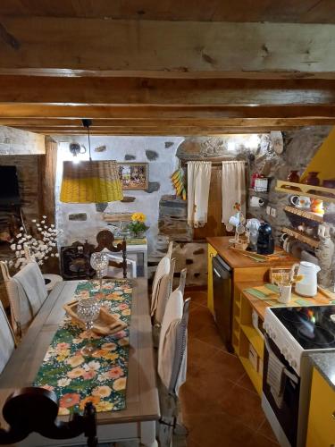 a kitchen with a table and a dining room at Talasnal Casas da Urze TER in Lousã