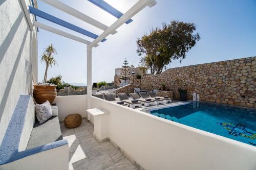 a villa with a swimming pool and a patio at Stavros Villas in Karterados