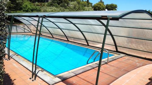 a canopy over a swimming pool on a house at Seven in Trecastagni