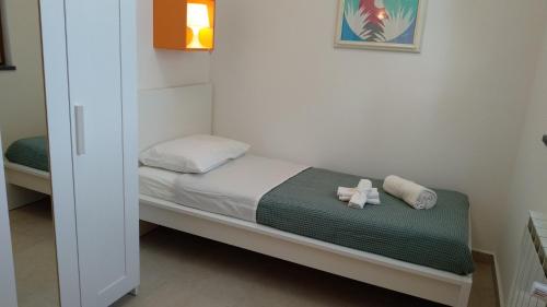 a small bedroom with a bed with a teddy bear on it at Seven in Trecastagni