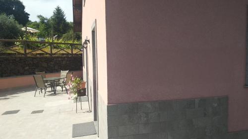 an open door to a patio with a table and chairs at Seven in Trecastagni