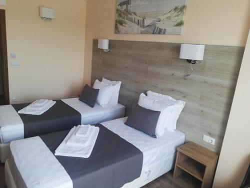 a hotel room with two beds and a picture on the wall at Hotel Vanilla, Varna - Free parking in Varna City