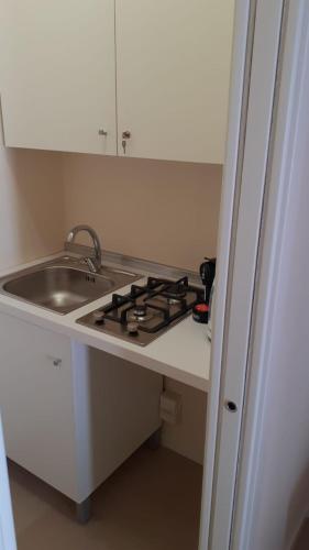 a kitchen counter with a sink and a stove at San Domenico Casa Vacanze in Modica