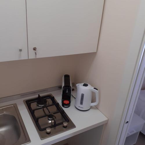a kitchen counter with a stove and a kettle on it at San Domenico Casa Vacanze in Modica