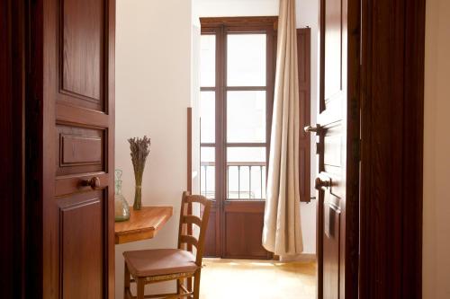 a room with a table and a chair and a window at Casal de Petra - Rooms & Pool by My Rooms Hotels TI in Petra