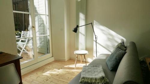 a living room with a couch and a dog looking out the window at Haus Münsterblick in Reichenau