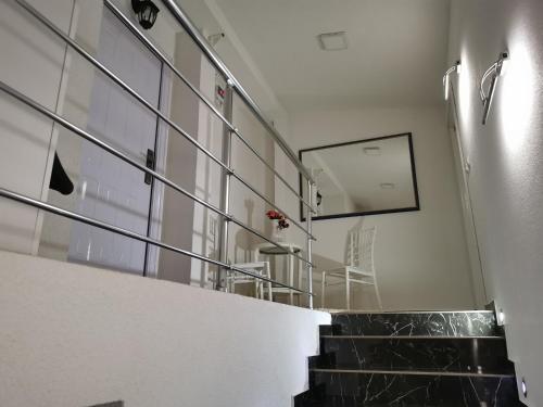 a hallway with a staircase with a mirror on the wall at Apartment Ain Naum in Ohrid